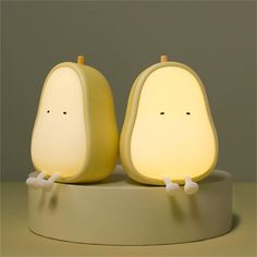 two pear shaped lamps sitting on top of a table