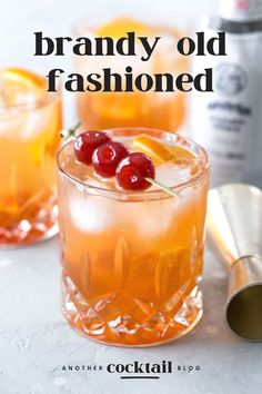 an old fashioned cocktail with cherries on the rim