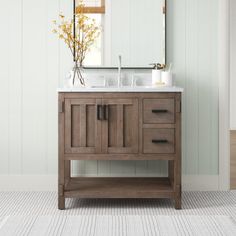 a bathroom vanity with two sinks and a mirror on the wall above it, along with a rug