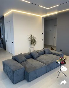 a large gray couch sitting in the middle of a living room