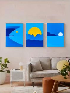 three paintings on the wall in a living room