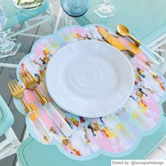 a table set with plates, silverware and utensils on top of it