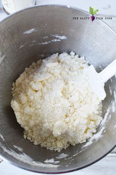 a metal bowl filled with white rice on top of a table