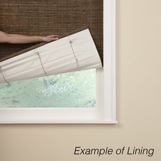 a woman is sitting on the window sill with her arm up and looking out