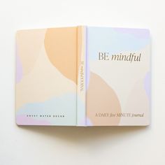 an open book with the words be mindful written on it's front cover