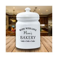 a white cookie jar with the words made with love grandma's bakery on it