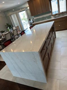 a large kitchen with an island in the middle and lots of counter space on the other side