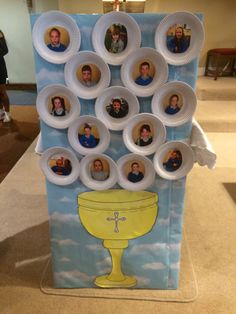 a table topped with paper plates and pictures of people in the cup on top of it