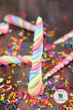 a birthday cake with sprinkles and a lit candle