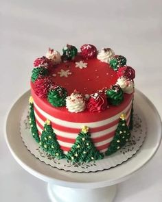 a red and white cake decorated with christmas decorations