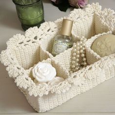 a white crocheted tray with soap and flowers