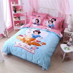 a bed room with a pink and blue comforter