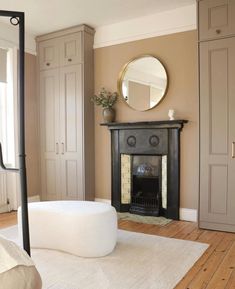 a living room with a fireplace and mirror