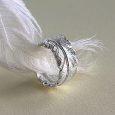 This on trend angelic accessory with make an amazing addition to any outfit. With its beautiful open style design this lovely piece is an incredibly adaptable ring. Feathers are often representatives of angels and protection, so whether its for someone special or a good luck charm just for you this flawless feather ring is perfect for starting a new life adventure.  With its adjustable design this ring can be gently squeezed to make it shrink or stretch accommodating a range of finger sizes. Make sure this one size fits all ring will be perfectly placed on you finger by drawing around the inside of a favourite fitted ring then measuring the diameter. All Martha Jackson jewellery comes in a gift box with a small gift card for you to write a message on made from: Sterling Silver. Keep clean Starting A New Life, Feather Ring Silver, Life Adventure, Feather Ring, Luck Charm, Feather Jewelry, Silver Feather, Affordable Jewelry, Ring Fit