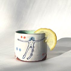 a small cup with a lemon slice in it