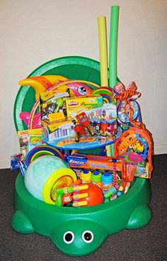 a green toy bucket filled with lots of toys