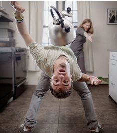 a man is upside down in the kitchen