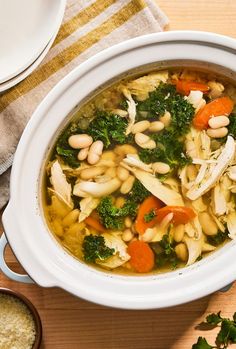 a white bowl filled with chicken and bean soup