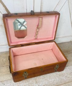 an old wooden box with a mirror in it