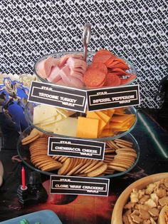 a table topped with lots of different types of snacks and crackers on top of it