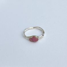 This exquisite ring is a unique creation, handcrafted with care and attention to detail. Made from sterling silver and adorned with a natural untreated pink sapphire, this one-of-a-kind piece is a true gem. The soft hue of the pink sapphire exudes elegance and charm, making it a perfect accessory for any occasion. The properties of the pink sapphire include promoting love, compassion, and emotional balance. Each facet of this ring reflects craftsmanship and the beauty of natural elements, ensuring that it stands out as a distinctive and timeless adornment. Embrace the allure of this exclusive handmade ring, designed to captivate and enhance your individual style. Size is 17.3mm Silver Pink Sapphire Rings For Gift, Silver Pink Sapphire Ring As Gift, Silver Jewelry With Pink Sapphire Gemstone, Fine Jewelry Pink Sterling Silver Ring, Silver Tourmaline Promise Ring, Pink Sapphire Sterling Silver Ring, Fine Jewelry Pink Sapphire Ring In Sterling Silver, Pink Sterling Silver Open Ring Jewelry, Pink Sapphire Ring In Sterling Silver