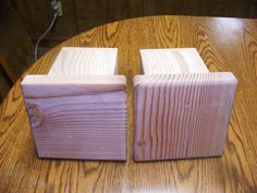 two pieces of wood sitting on top of a wooden table