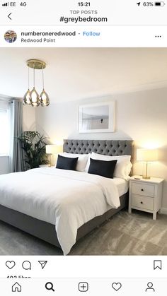 a bed room with a neatly made bed and two lamps on either side of the bed