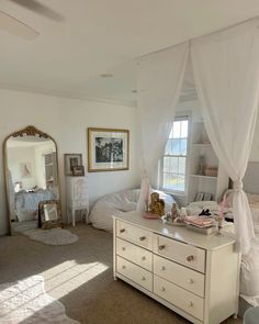 a bedroom with a bed, dresser and mirror in it's centerpieces