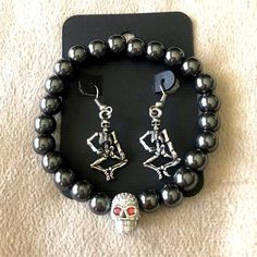 Halloween Skeleton Earrings & Bracelet Set. Full Body Skeleton Earrings With Matching Gun Metal Beaded Bracelet With Rhinestone Skull Head. Get Halloween Ready With This Spooky Set. Edgy Handmade Jewelry Gift, Handmade Edgy Jewelry For Gifts, Punk Alloy Jewelry For Halloween, Black Alloy Halloween Jewelry, Punk Metal Jewelry For Gifts, Black Alloy Jewelry For Halloween, Black Sterling Silver Skull Jewelry, Black Skull Sterling Silver Jewelry, Punk Stainless Steel Jewelry For Party