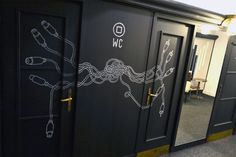 several black doors with white drawings on them