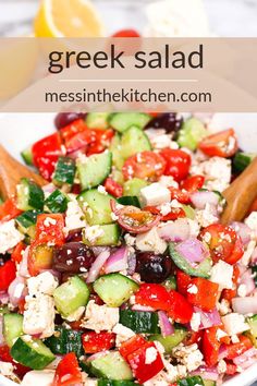 greek salad with cucumbers, tomatoes, olives and feta cheese in a white bowl