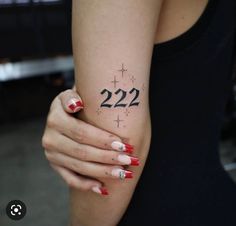 a woman's arm with the number 22 on it and stars around her wrist