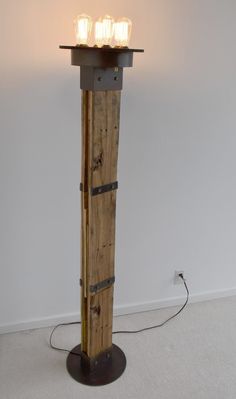 a light that is sitting on top of a wooden pole in the middle of a room