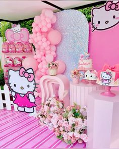 a hello kitty themed birthday party with balloons and decorations