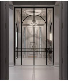 an open glass door leading to a foyer with chandelier hanging from the ceiling