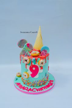 there is a colorful cake decorated with donuts and ice cream