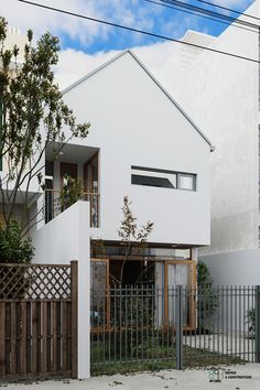 a white house with a black fence in front of it