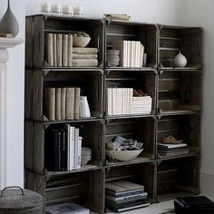 a bookshelf filled with lots of books next to a fireplace