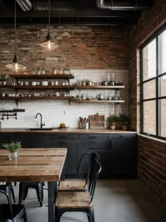 an industrial style kitchen with exposed brick walls and dark wood furniture, along with open shelving