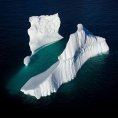 an iceberg floating in the middle of the ocean