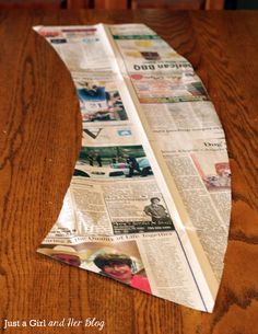 a piece of newspaper sitting on top of a wooden table