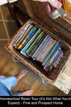 someone is holding a basket full of books