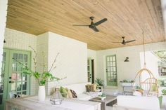 a living room filled with furniture and a ceiling fan