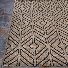 the rug is made from jute and has an intricate design on top of it