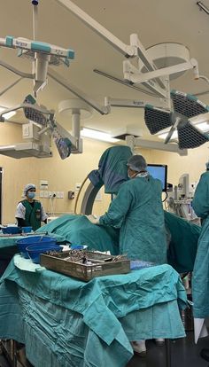 doctors in scrubs perform surgery on an operating room