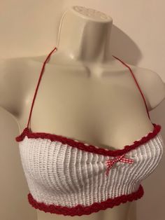 a mannequin wearing a white top with red trimmings on the bottom