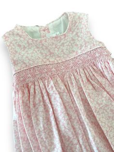 Reference: V064 Color: Pink Materials: 100% cotton Intended Age: Toddler Girl, Girl Description: This dress is perfect for spring & summer. The sleeveless dress has a smock strip on the waist in white and pink details. It has a square collar with piping and it has buttons in the back for fastening. Fully lined, hand smocked. Size Guide: Runs Small. Please size up +1 from your regular size. Smock Dress Pattern, Smocking Designs, Kids Smock, Smocking Dress, Smocking Tutorial, Smocking Plates, Hand Smocked Dress, Smocked Baby Dresses, Frocks Design