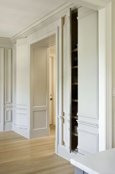 an empty room with white walls and wooden floors is seen in this image from the doorway