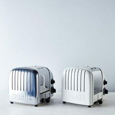 two toasters sitting side by side on a table