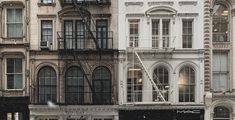 an old building with many windows and fire escapes